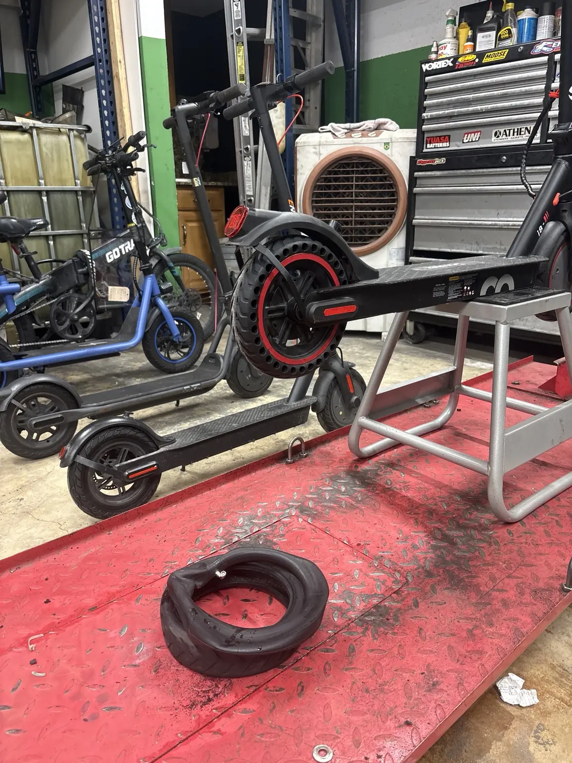 New red-accent solid tire installed on an electric scooter motor wheel